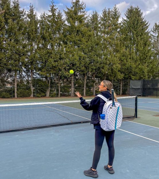 Sassy Li customer on the court with the white tennis bag
