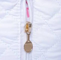 Gold racket-shaped zipper pull detail